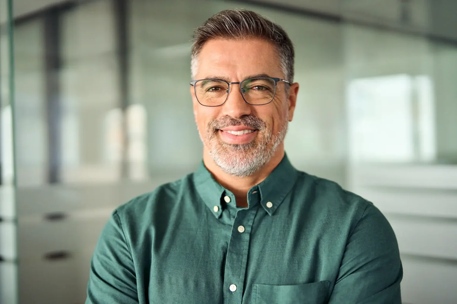 Smiling man with beard in a modern workplace